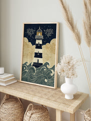 Illustrative lighthouse wall art with navy and white stripes, golden clouds, and crashing, in an alternate framed mockup
