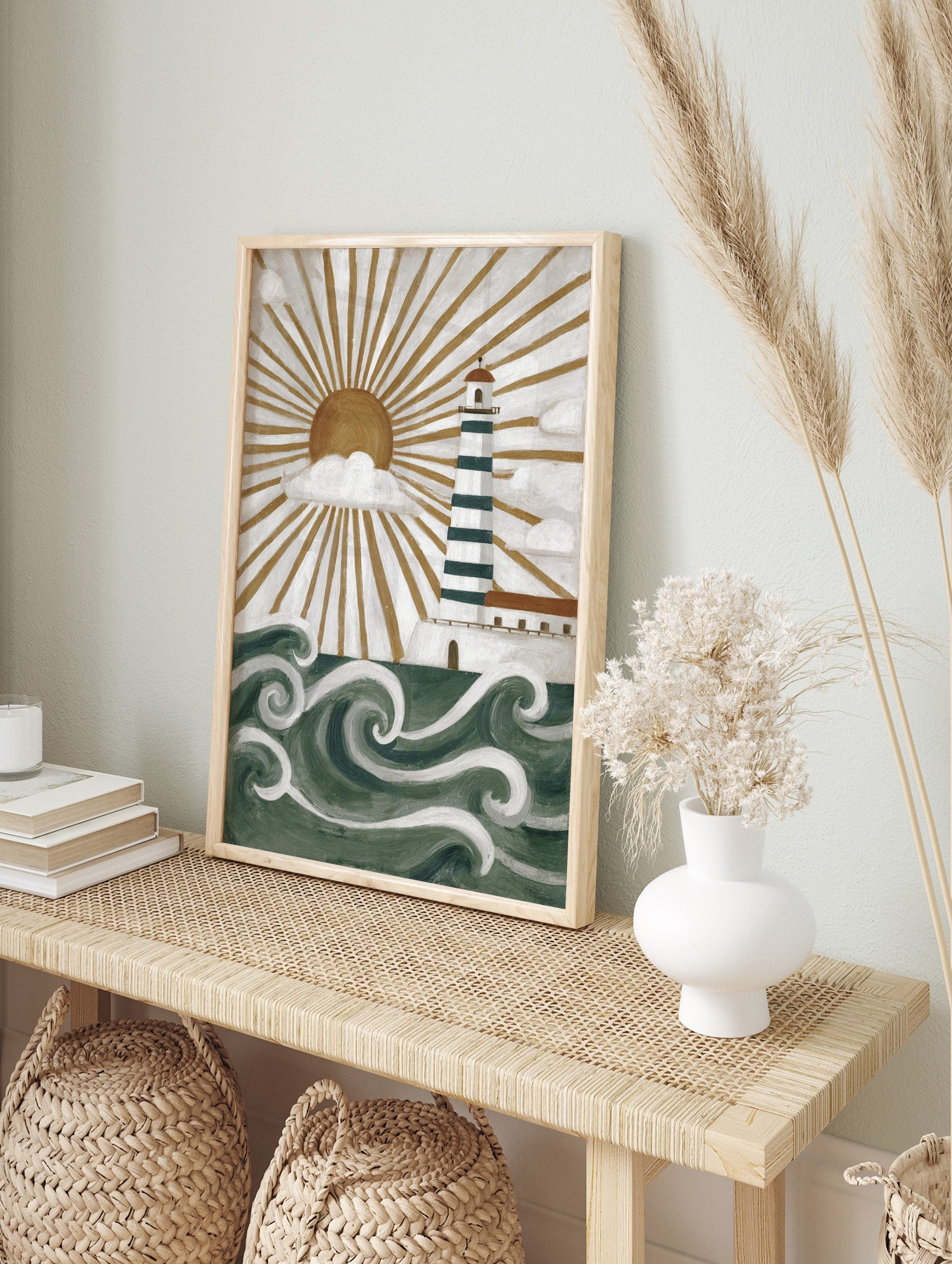 Illustrative lighthouse wall art with green and white stripes, golden sunburst, white clouds, in an alternate framed mockup