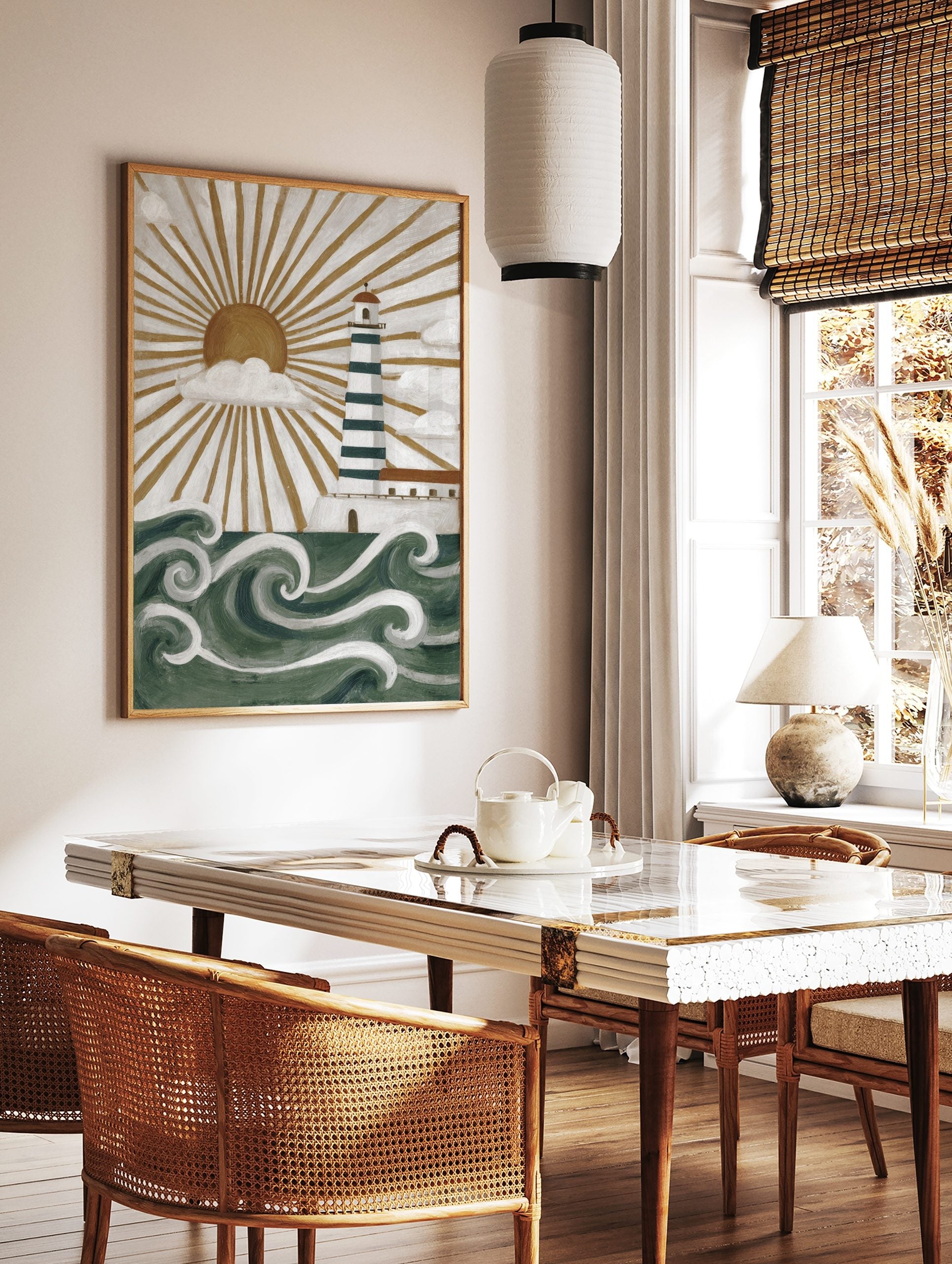 Illustrative lighthouse wall art with green and white stripes, golden sunburst, white clouds, and, in a styled room mockup