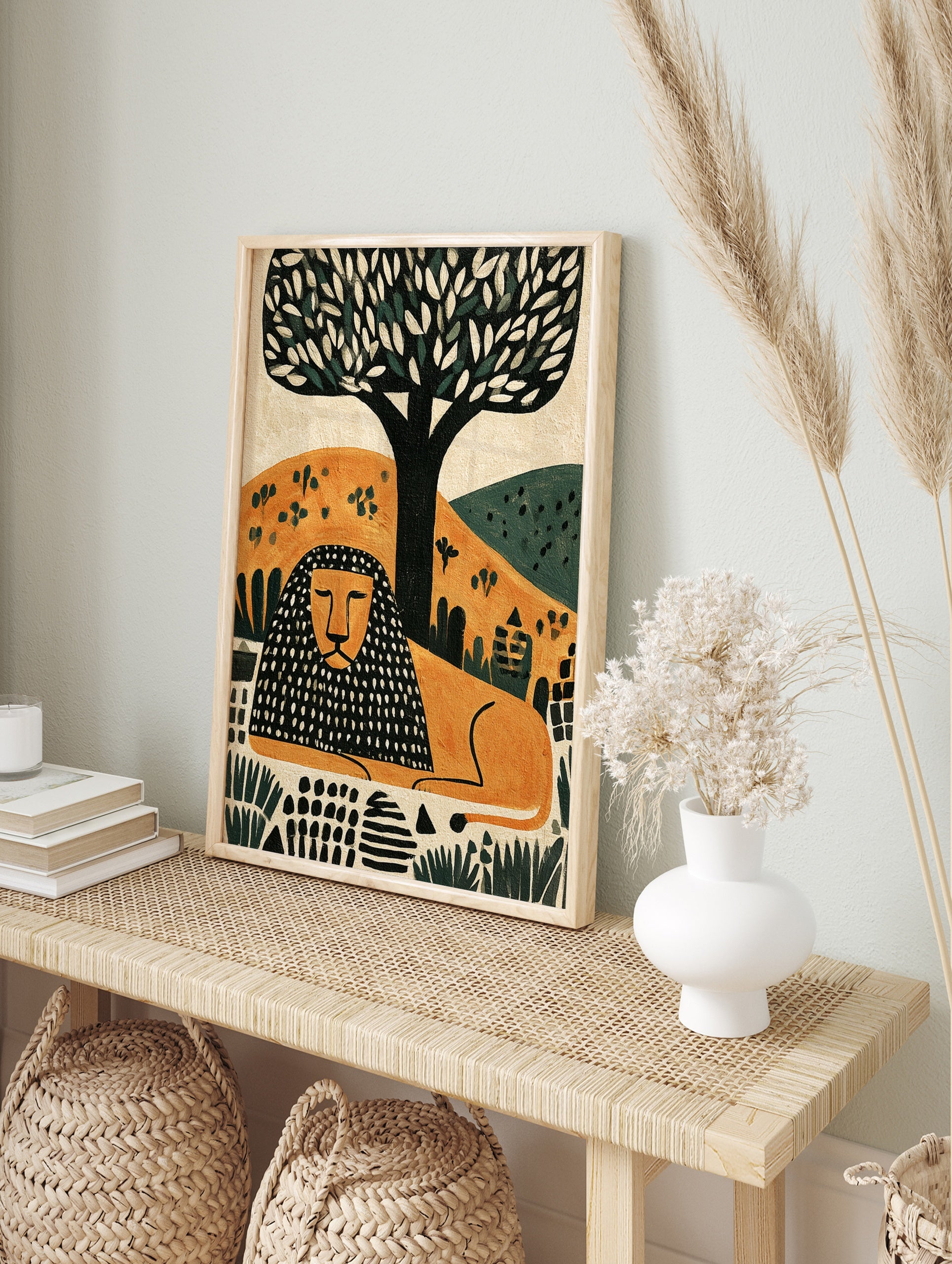 Modern illustrative lion wall art print with a black and orange patterned mane resting under, in an alternate framed mockup