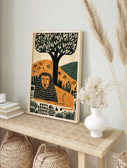 Modern illustrative lion wall art print with a black and orange patterned mane resting under, in an alternate framed mockup