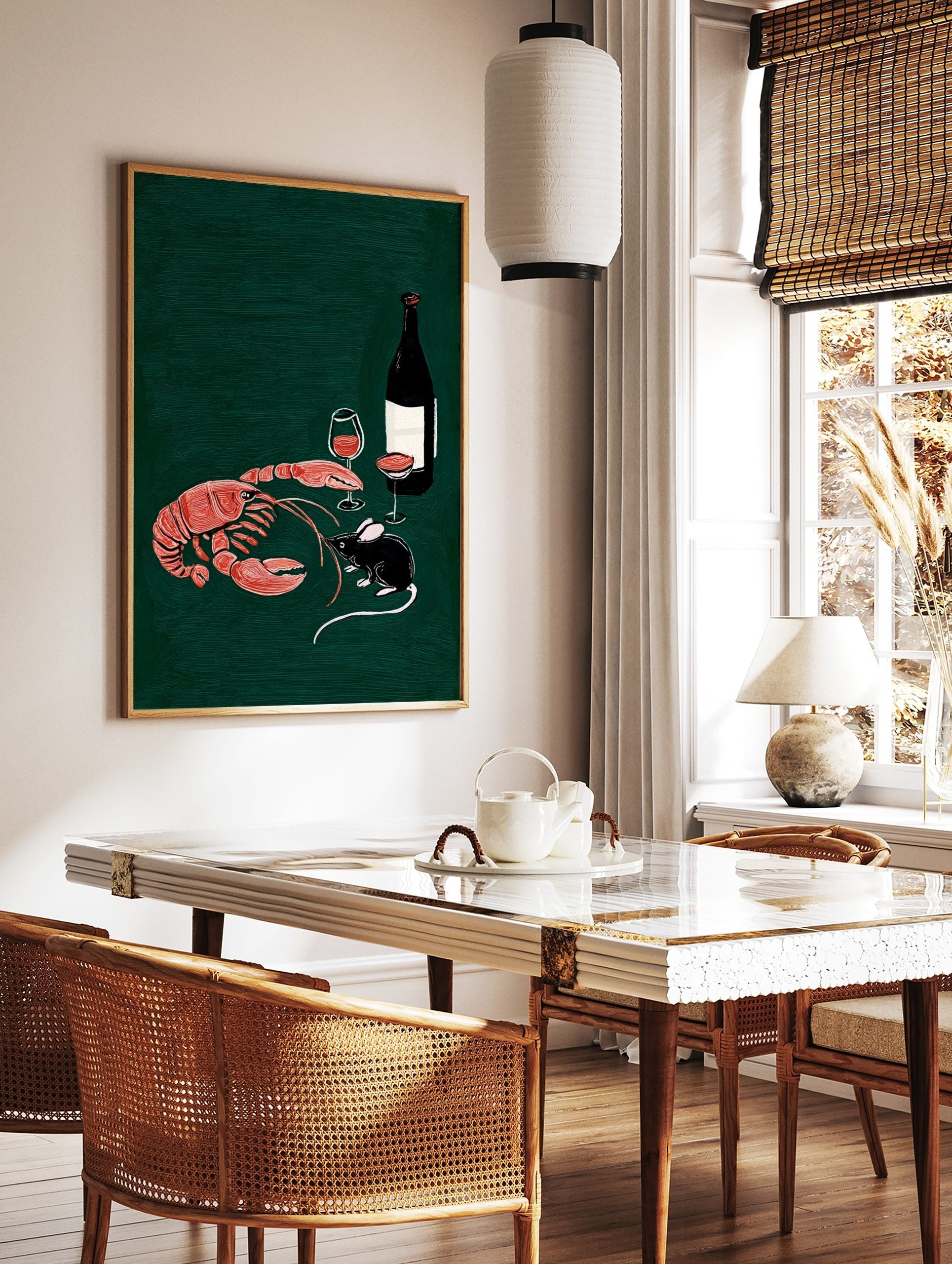 Illustrative print of a red-orange lobster, black mouse, wine bottle, and glasses on a dark green, in a styled room mockup