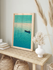 Textured woodblock print of a lone person in a boat on a teal-blue sea under a light sky, in an alternate framed mockup