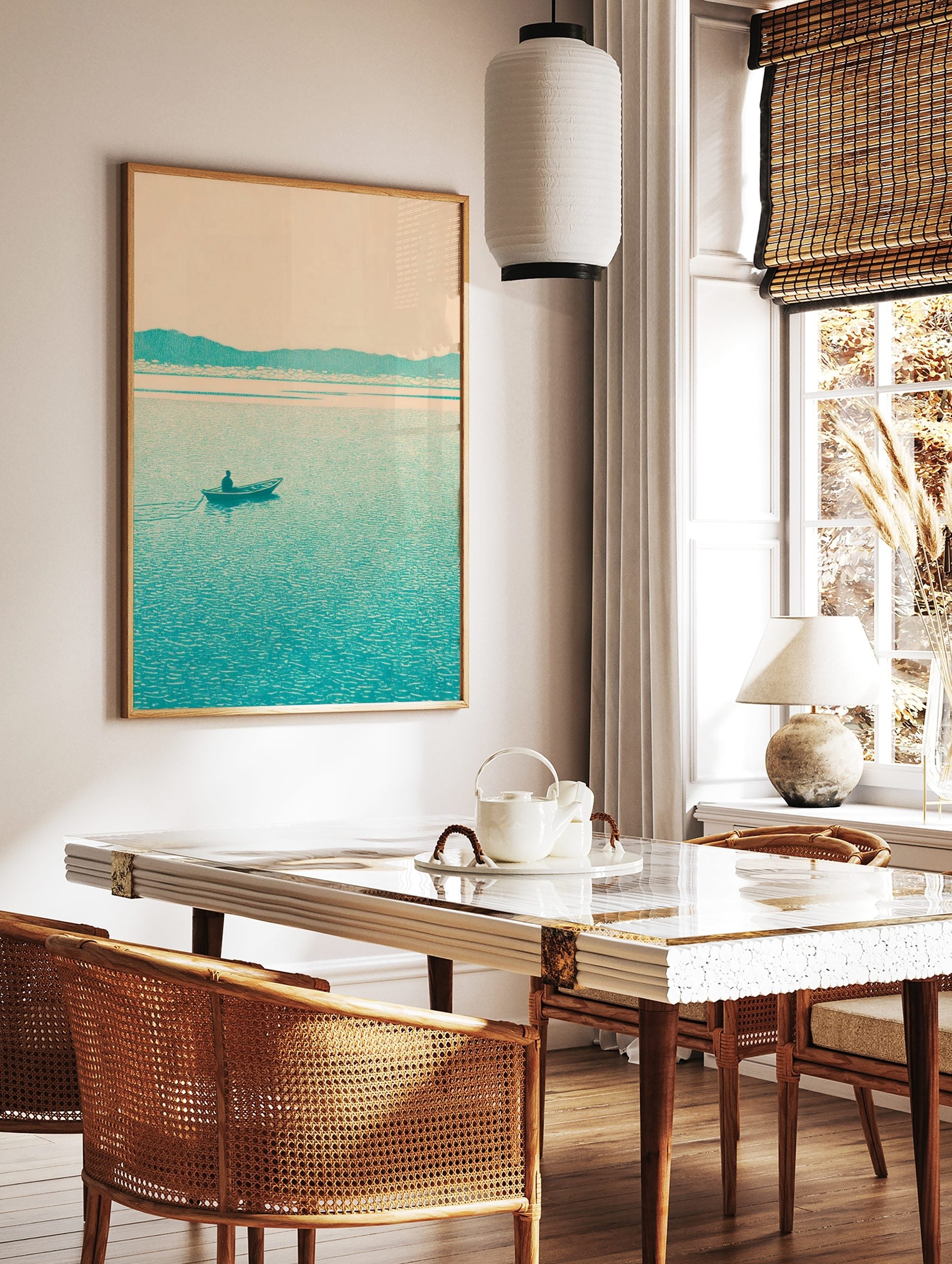 Minimalist teal landscape print with a lone boatman on a lake and distant mountains under a pale sky, in a styled room mockup