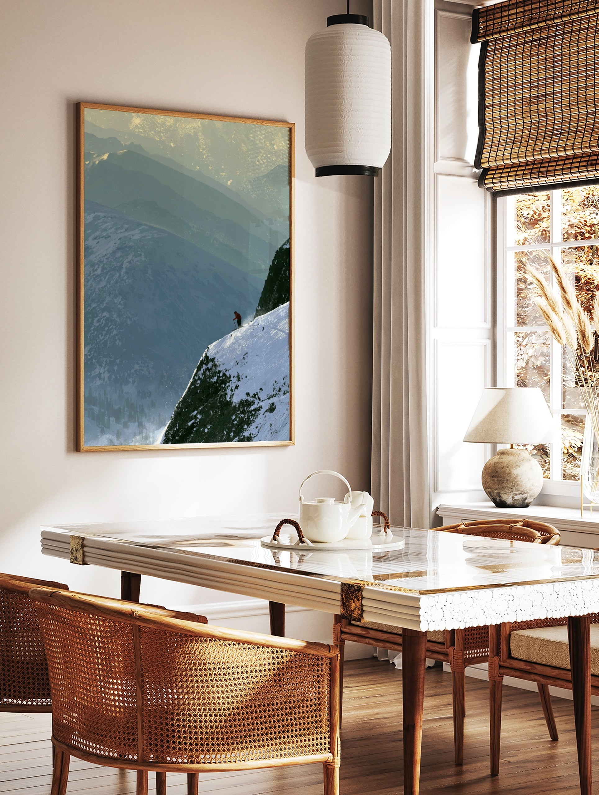 Lone skier in an orange jacket on a steep, snow-covered mountain ridge with layered peaks in the, in a styled room mockup