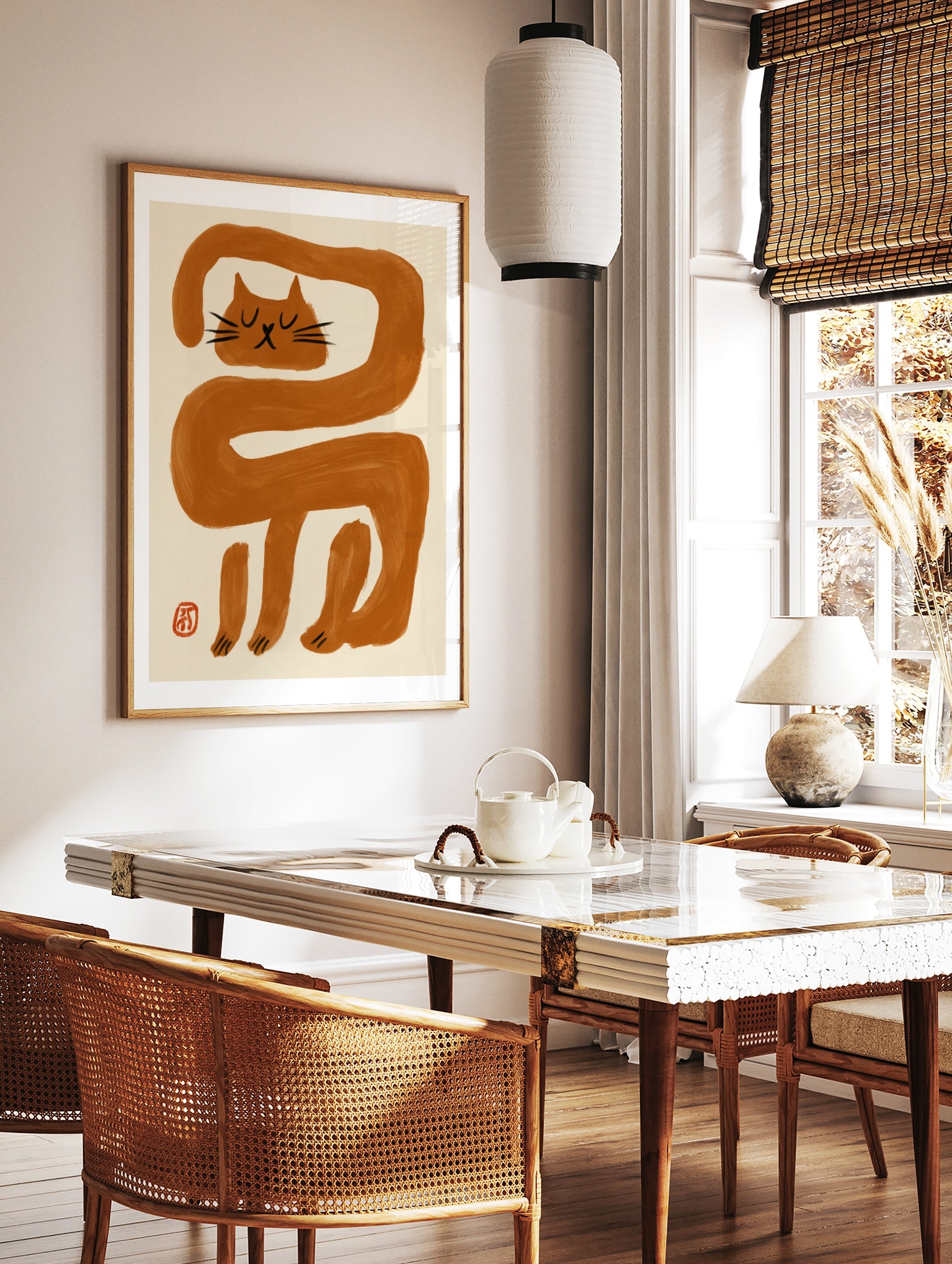 Minimalist wall art print featuring an elongated orange cat illustration with black facial features, in a styled room mockup