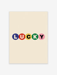 Typography wall art with the word LUCKY in blue, red, yellow, green, and pink circles on a cream background