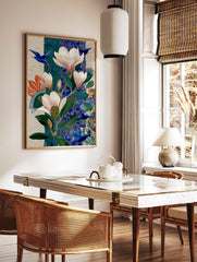 Illustrative botanical art print with pink magnolias, green leaves, and flying blue birds on a, in a styled room mockup