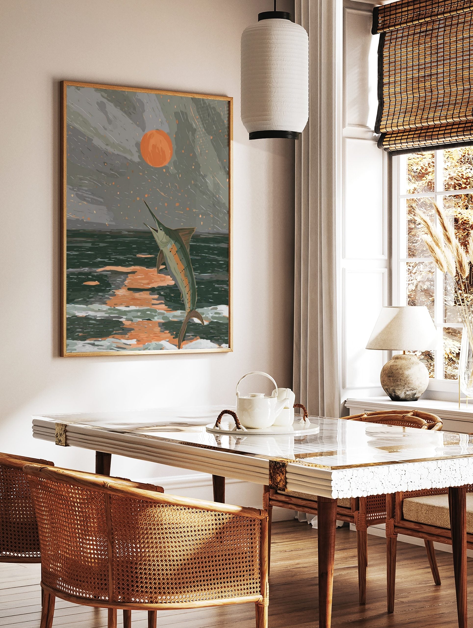Illustrative art print of a marlin jumping from dark ocean waves under an orange sun in a grey sky, in a styled room mockup