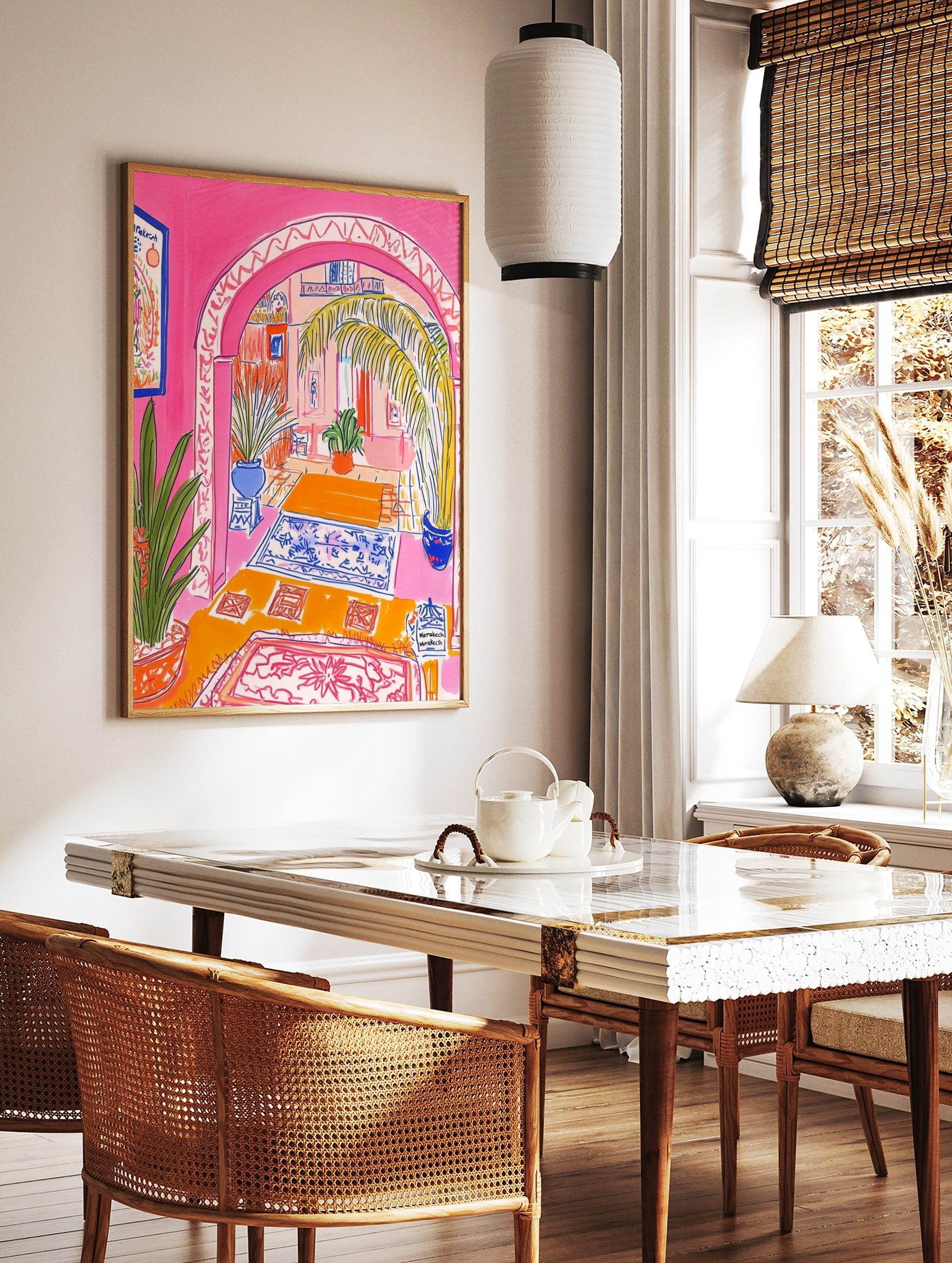 Vibrant illustrative print of a Moroccan archway interior with pink walls, palm tree, and blue, in a styled room mockup