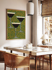Illustrative martini cocktail glasses with black liquid and white rim on a green background with, in a styled room mockup