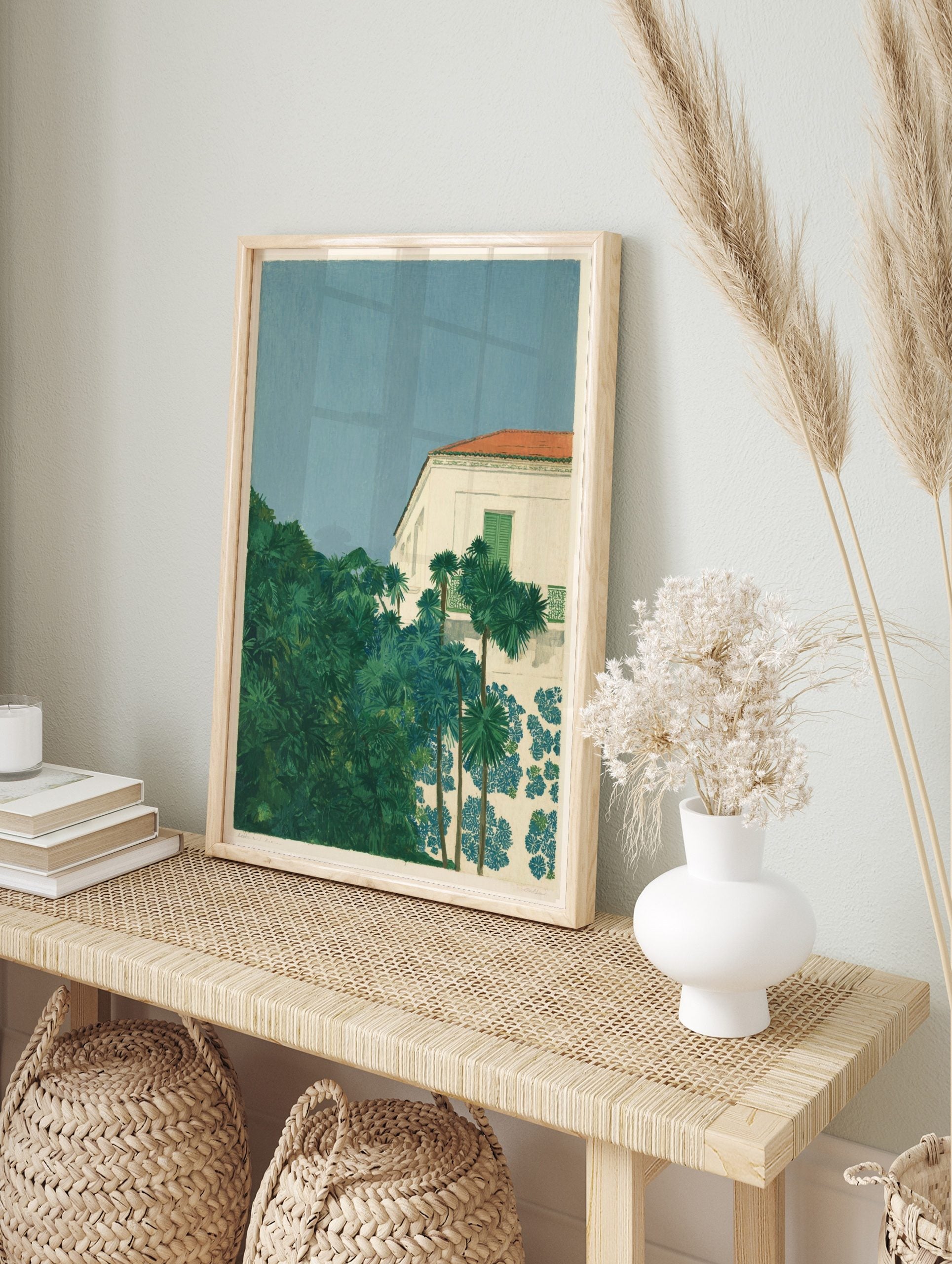 Mediterranean villa with red roof, green shutters, lush palm trees, and blue floral patterns, in an alternate framed mockup