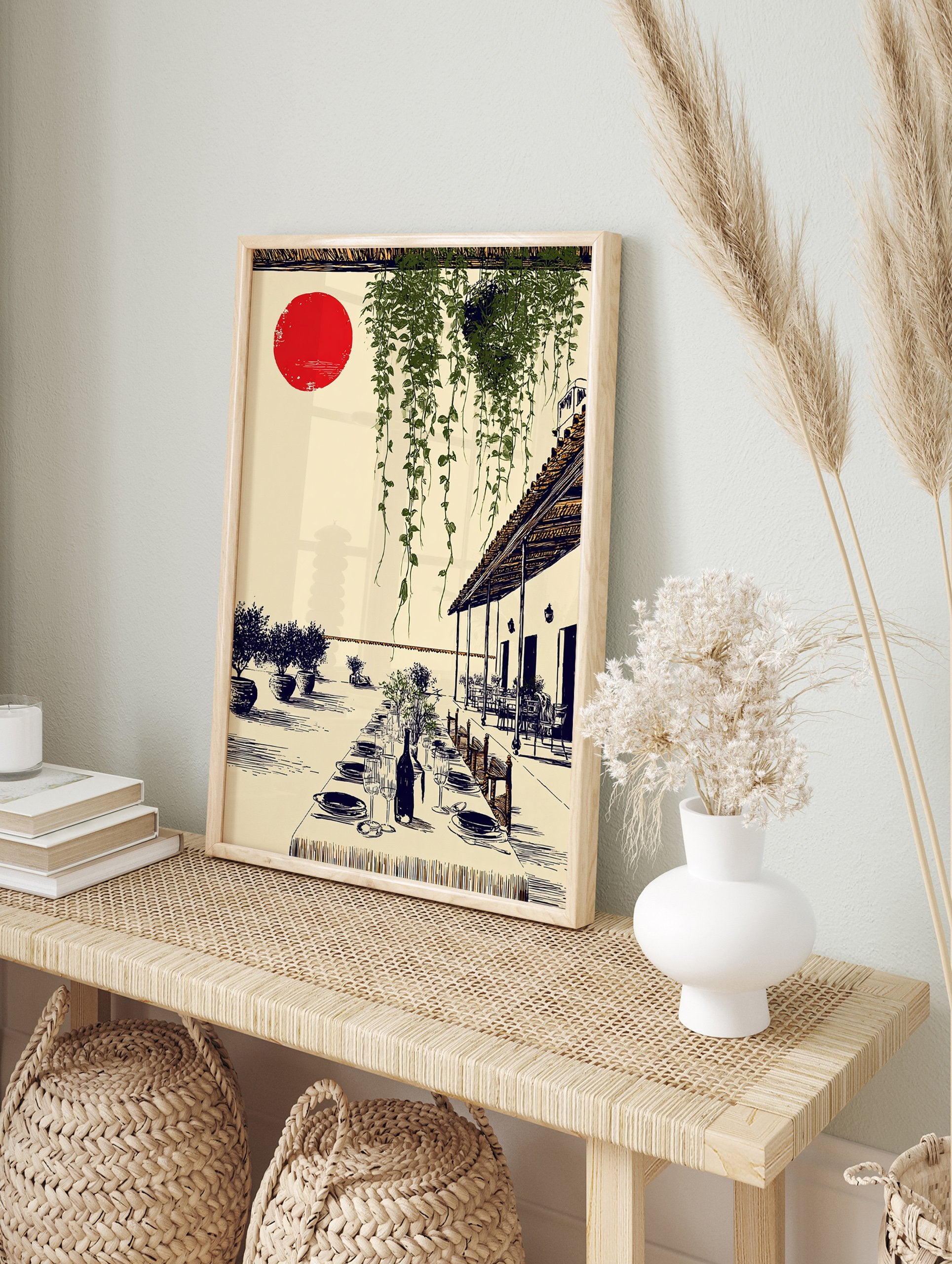Mediterranean wall art illustration of an outdoor dining patio with a long table, green vines, and a red sun. - Image 3