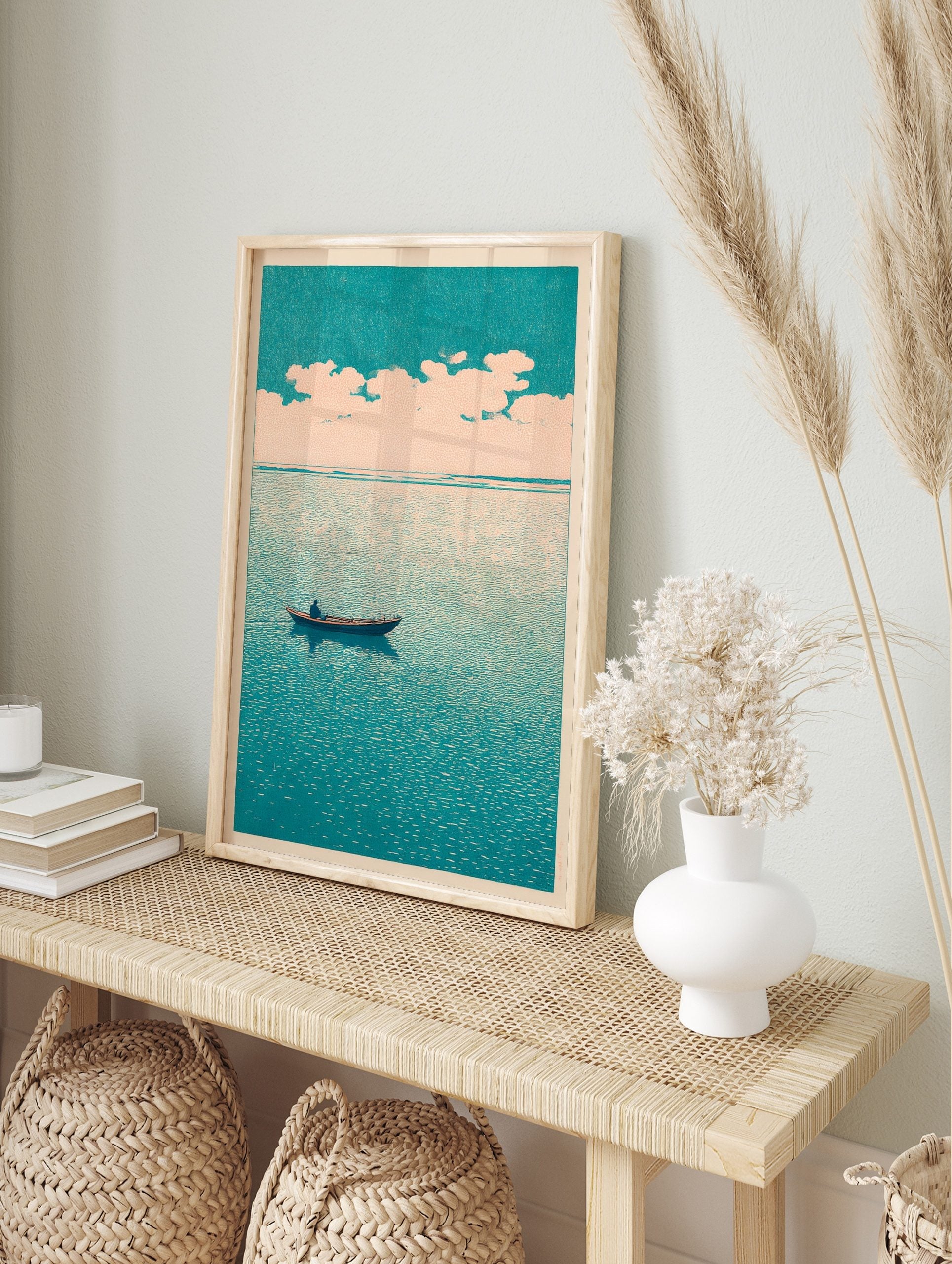 Minimalist art print of a lone boat on a teal sea under a pale, cloudy sky, evoking calm, in an alternate framed mockup