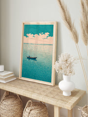Minimalist art print of a lone boat on a teal sea under a pale, cloudy sky, evoking calm, in an alternate framed mockup