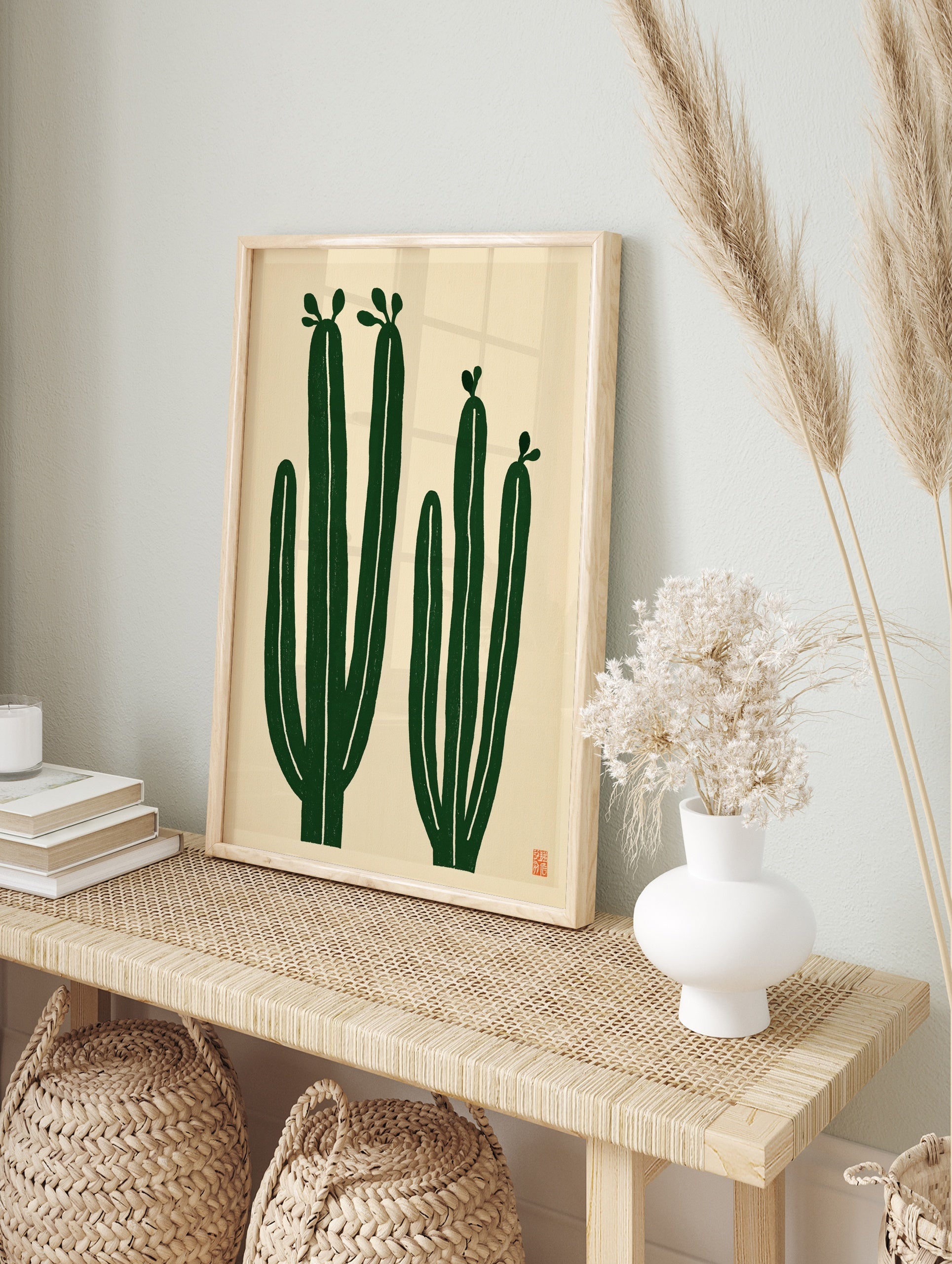 Minimalist cactus wall art with two green cacti on a cream background, illustrative botanical, in an alternate framed mockup