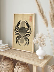 Minimalist black crab illustration with horizontal lines on beige paper, red grid in top right, in an alternate framed mockup