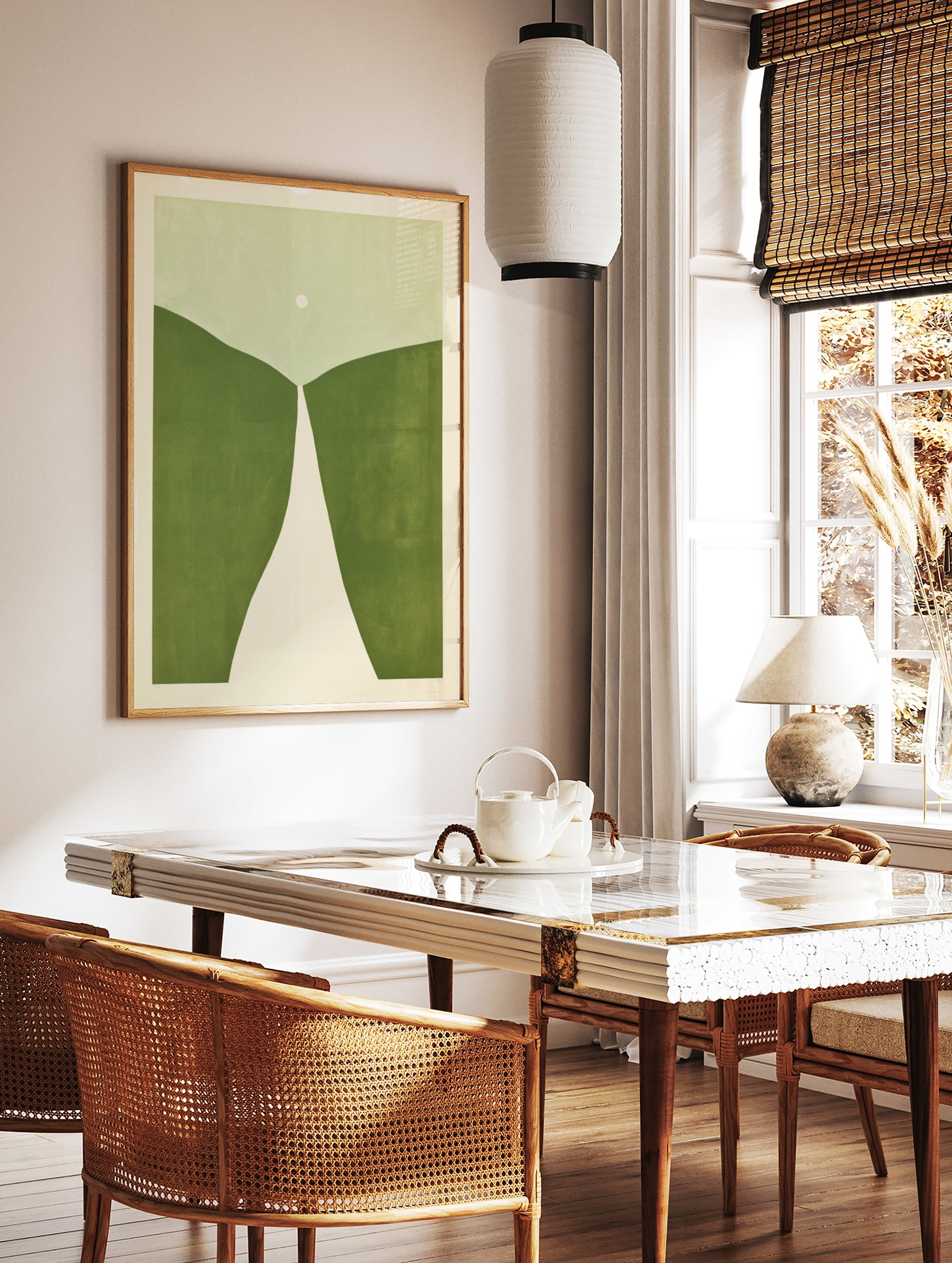 Minimalist abstract art print with rolling green hills, a white path, and a pale circle on a light, in a styled room mockup