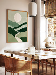 Minimalist green landscape wall art with rolling hills, a central winding path, and a large pale, in a styled room mockup