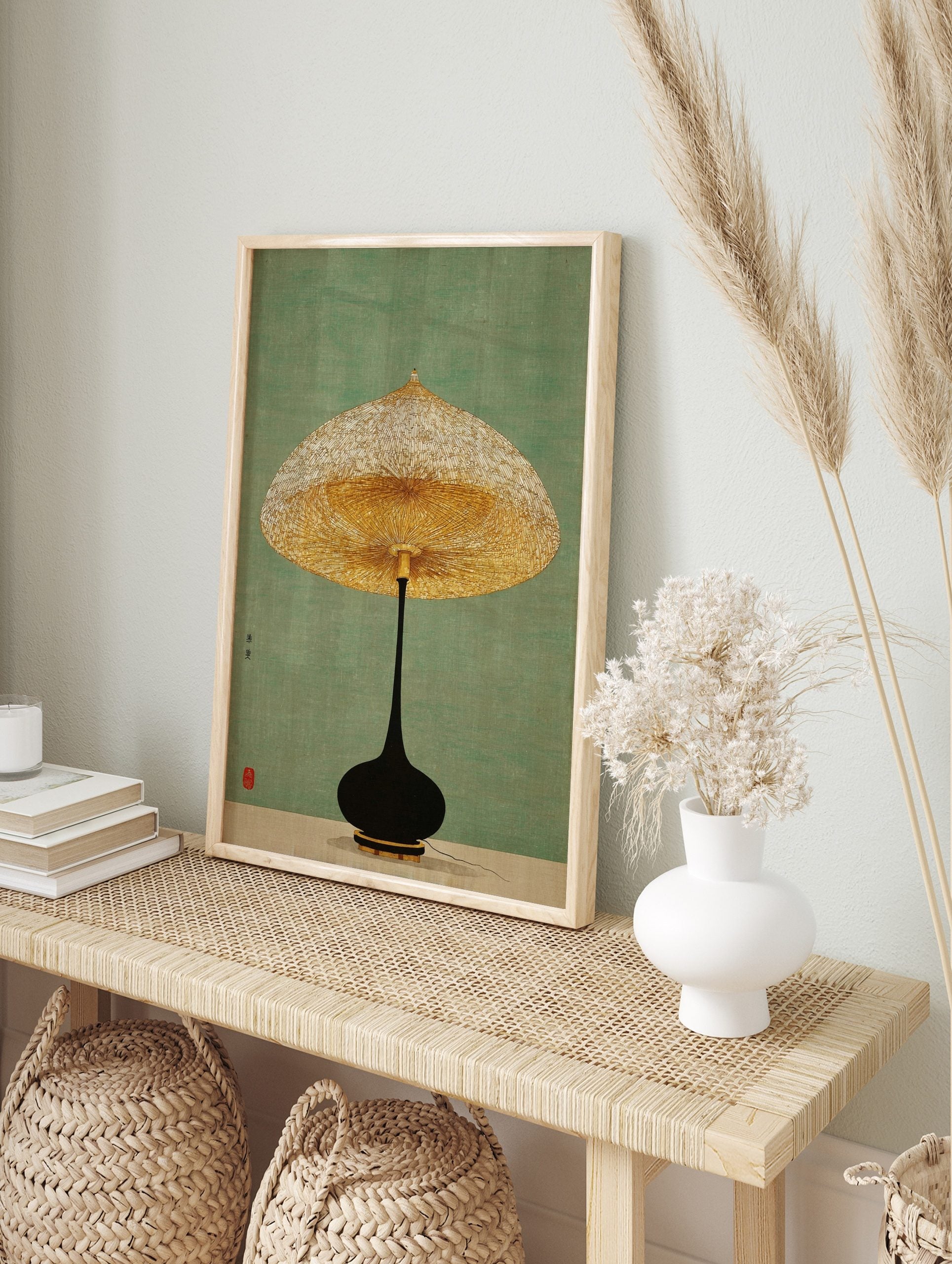 Minimalist lamp wall art with a golden textured shade and black base on a green background, in an alternate framed mockup