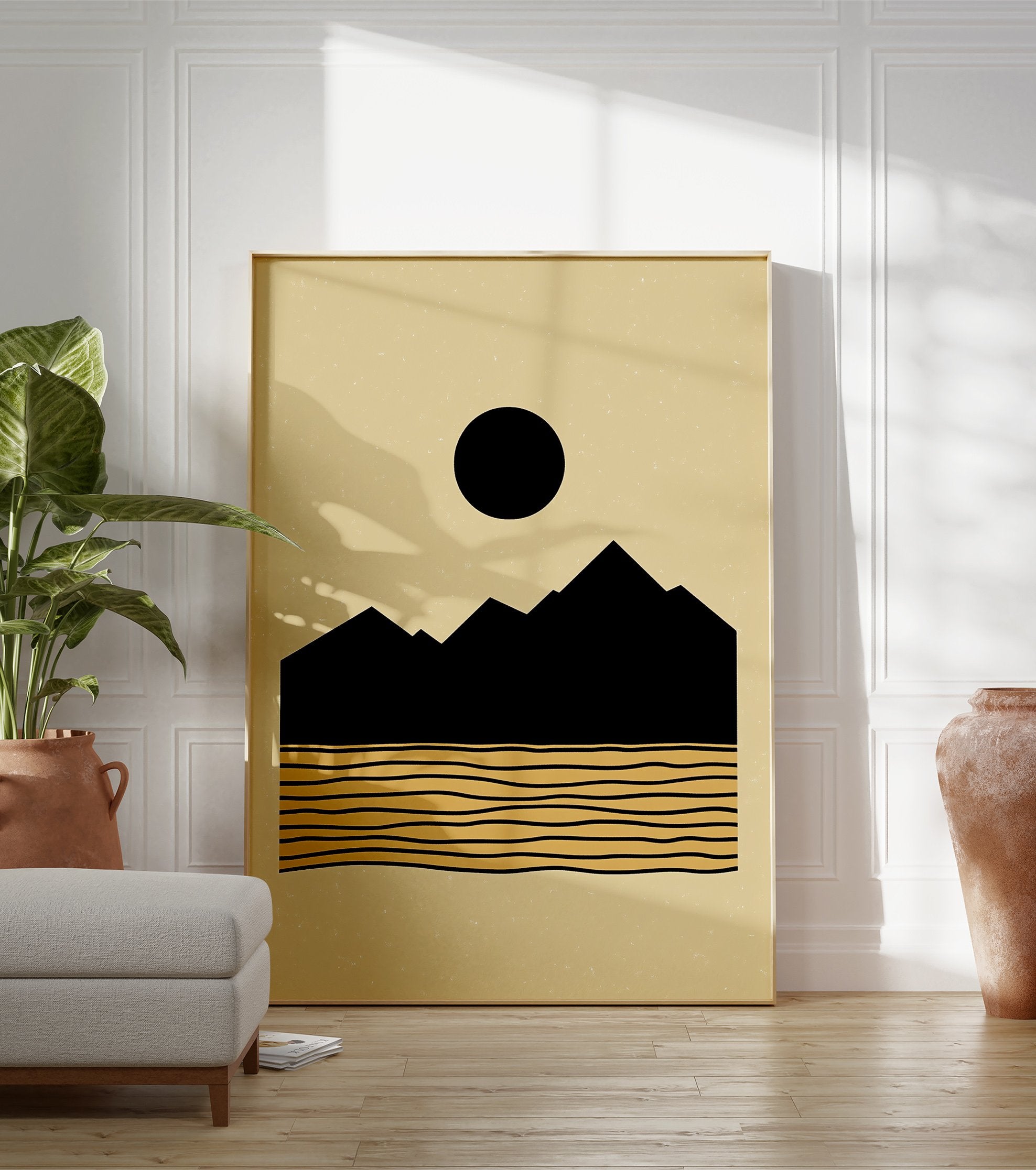 Minimalist landscape poster with black mountains, a black sun, and golden wavy lines representing water on a beige background. - Image 3