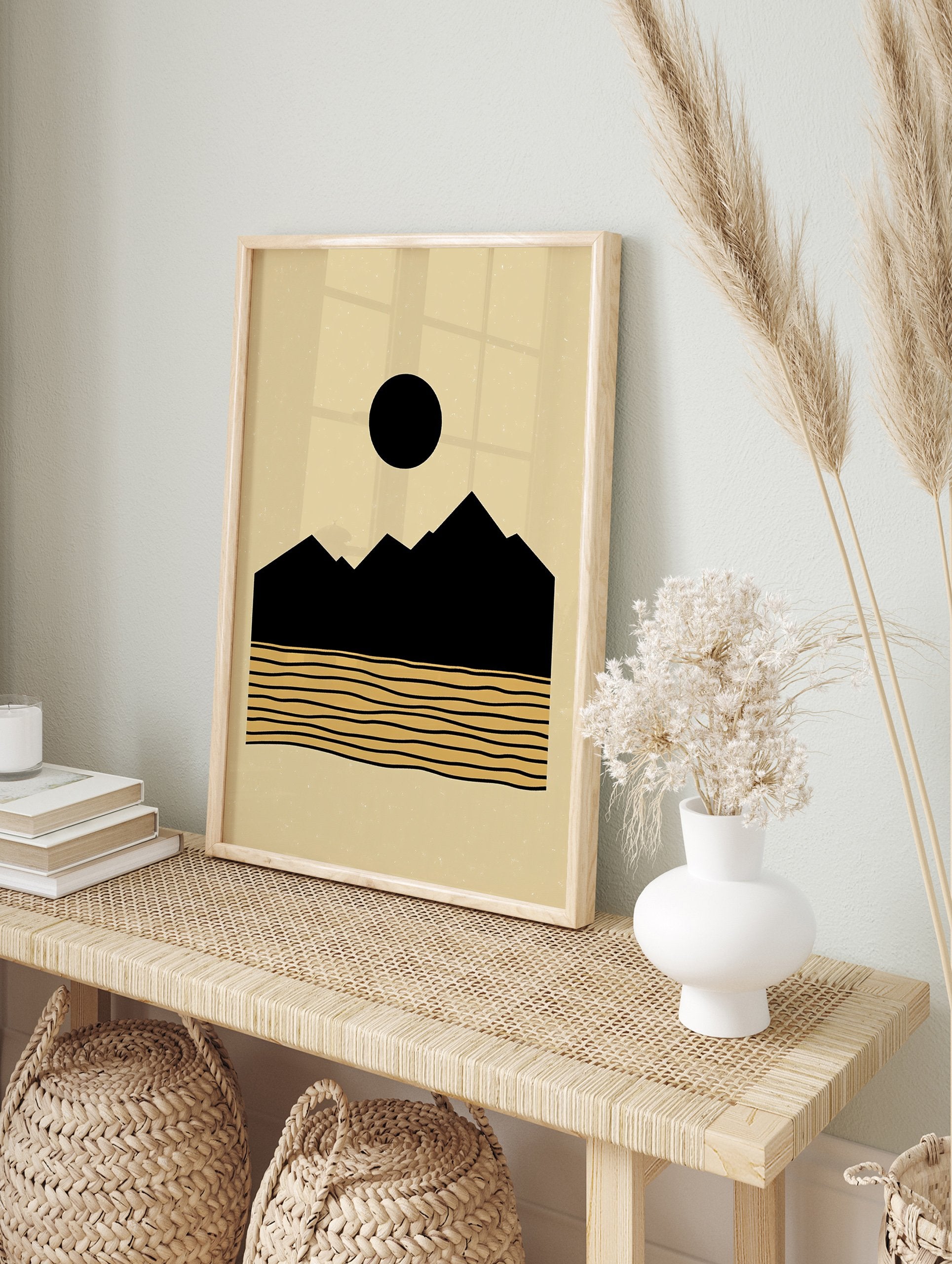 Minimalist landscape poster with black mountains, a black sun, and golden wavy lines representing water on a beige background. - Image 4