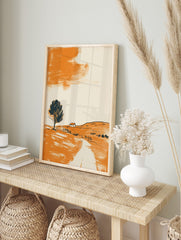Minimalist landscape art print with orange hillside, dark tree, small house, and abstract, in an alternate framed mockup