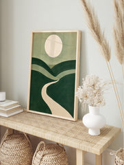 Minimalist landscape art print with rolling green hills, a winding beige path, and a large, in an alternate framed mockup