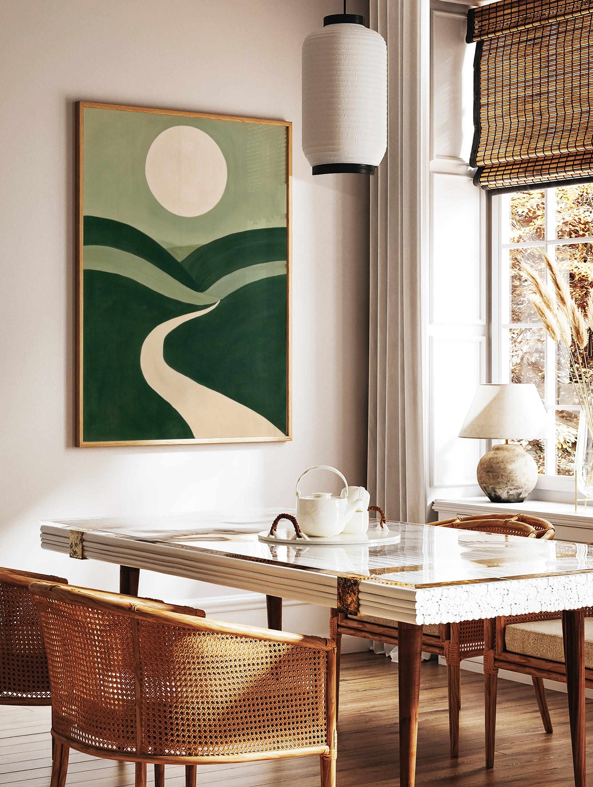 Minimalist landscape art print with rolling green hills, a winding beige path, and a large pale, in a styled room mockup