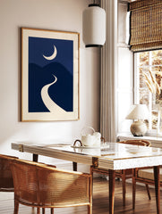 Minimalist night landscape art print with a cream crescent moon over navy blue rolling hills and a, in a styled room mockup