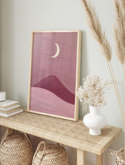 Minimalist moon landscape art print featuring a cream crescent moon above rolling pink and, in an alternate framed mockup