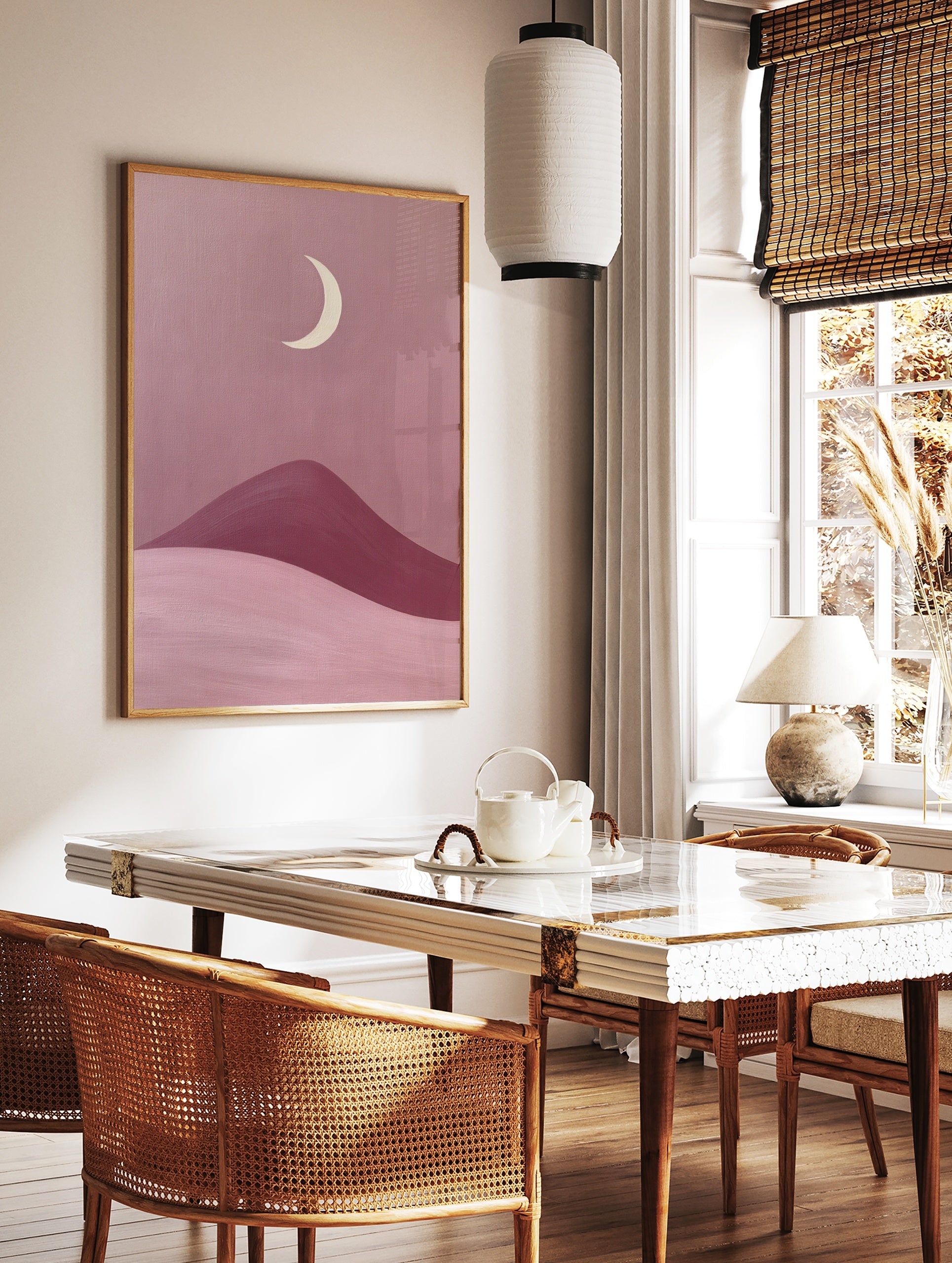 Minimalist moon landscape art print featuring a cream crescent moon above rolling pink and berry, in a styled room mockup