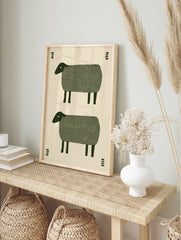 Minimalist folk art print featuring two stacked green sheep illustrations with small, in an alternate framed mockup