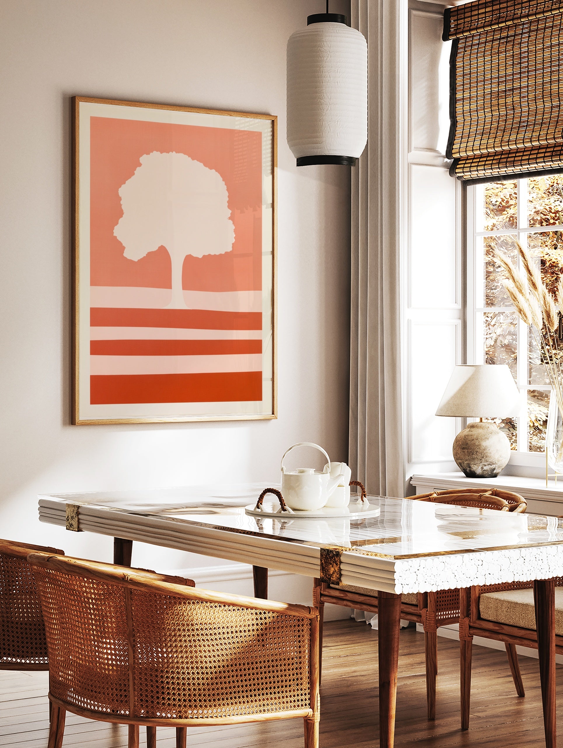 Minimalist tree silhouette art print with horizontal stripes in warm coral and peach tones on a, in a styled room mockup