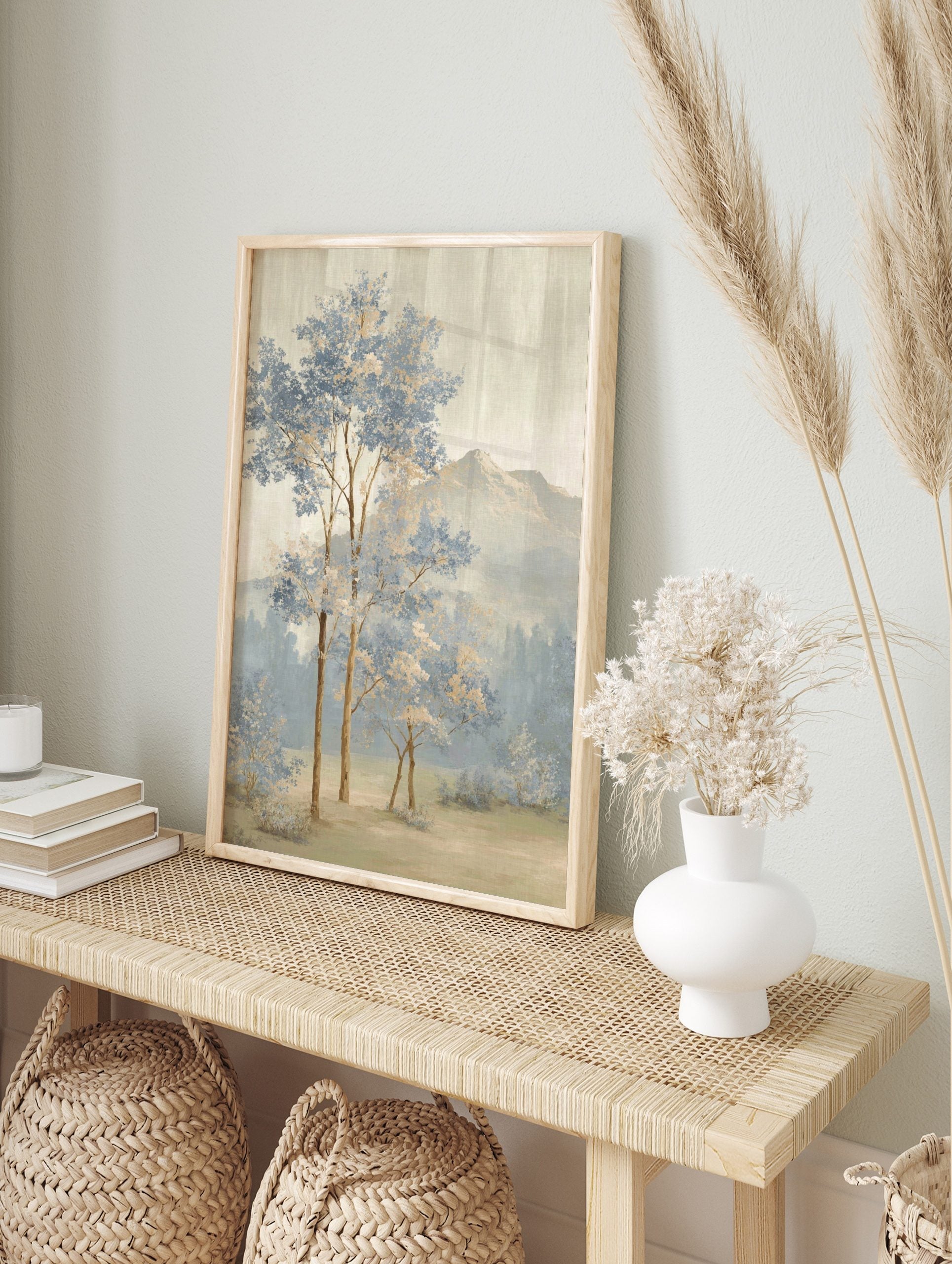 Painterly landscape art print with blue and beige trees, misty forest, and distant mountains, in an alternate framed mockup