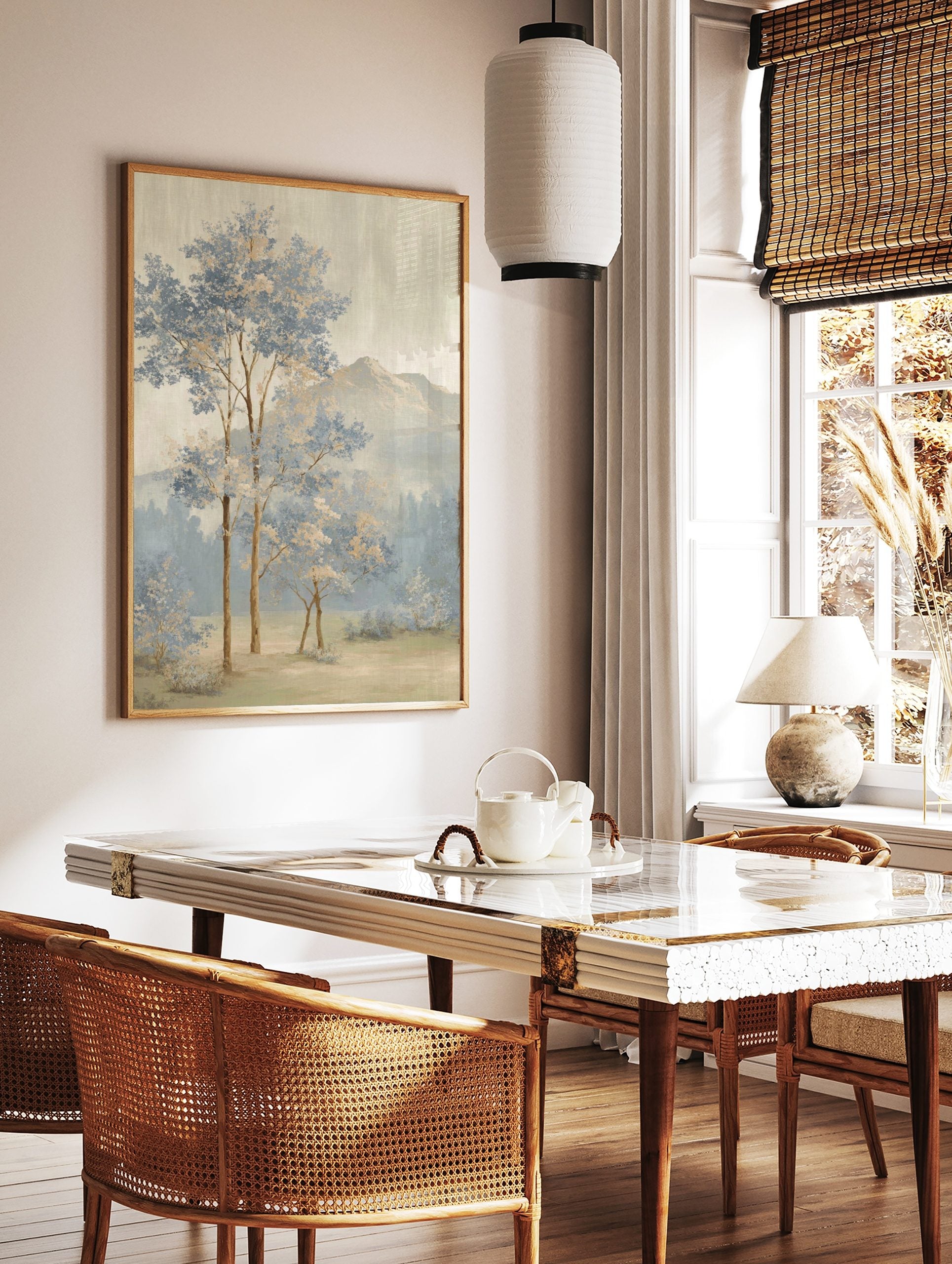 Painterly landscape art print with blue and beige trees, misty forest, and distant mountains under, in a styled room mockup