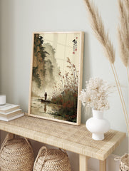 East Asian ink wash landscape print of a fisherman in a boat with misty mountains and reeds, in an alternate framed mockup