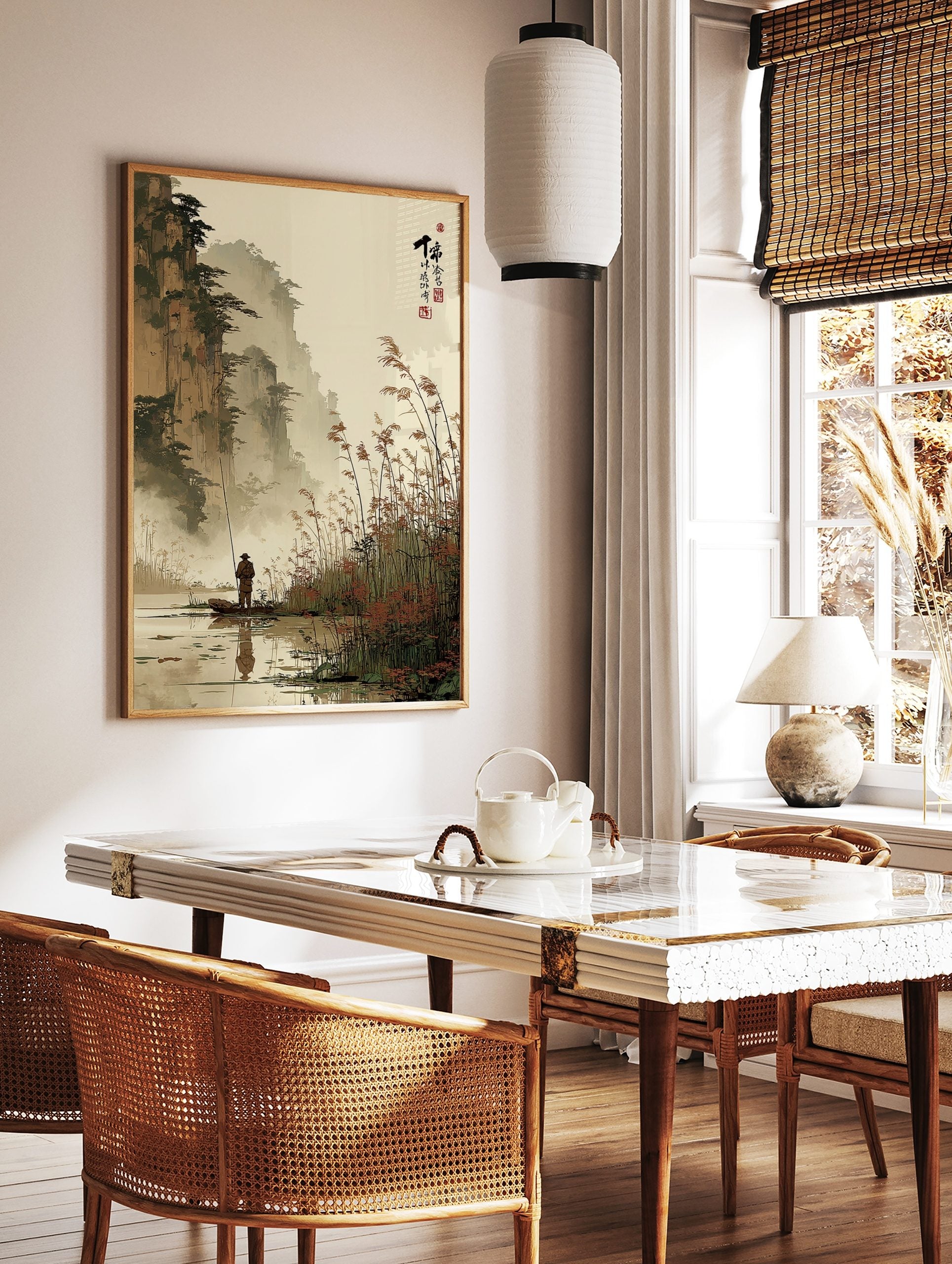 East Asian ink wash landscape print of a fisherman in a boat with misty mountains and reeds, in a styled room mockup