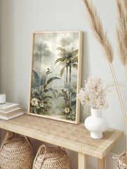 Misty tropical jungle art print with large green leaves, palm trees, a small bird, and white, in an alternate framed mockup