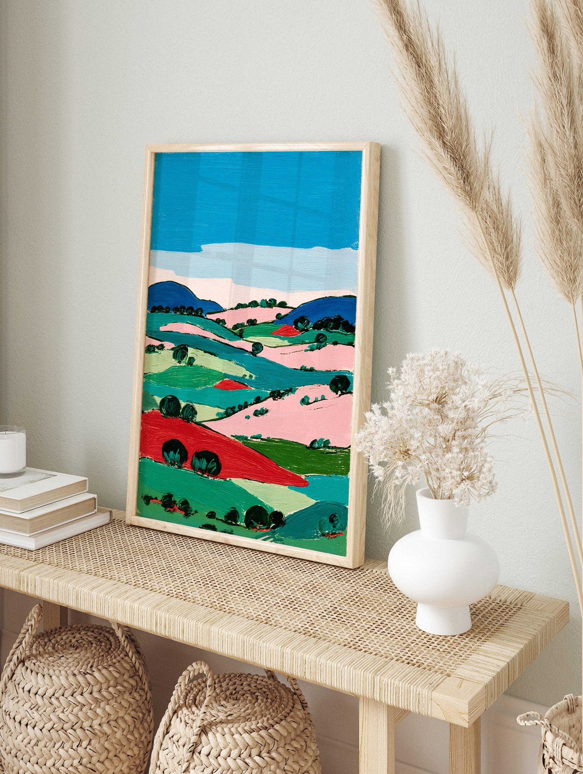 Vibrant modern landscape wall art painting featuring rolling hills, fields, and trees in bold blue, green, pink, and red colors under a blue sky. - Image 3