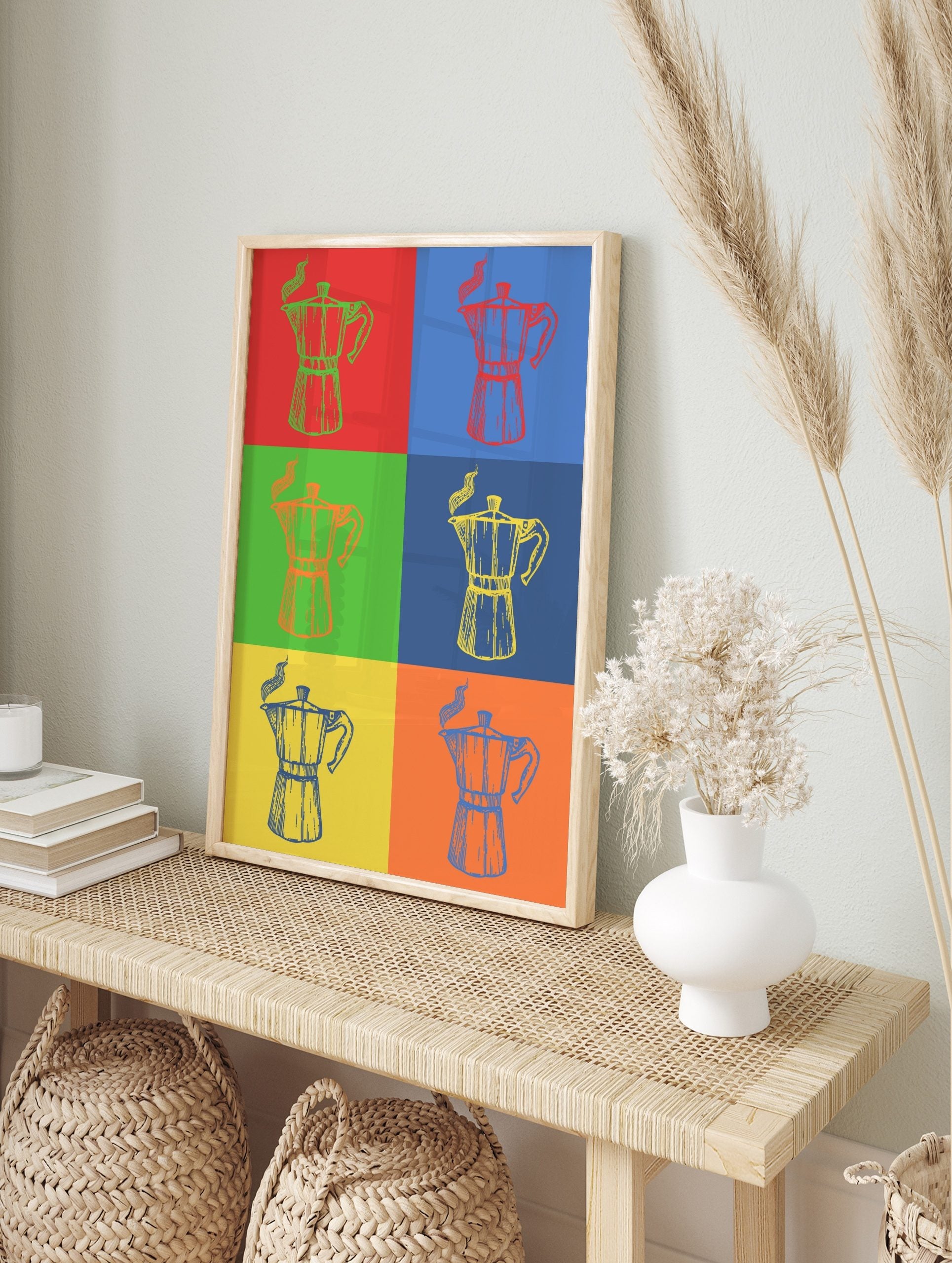 Multi-color pop art style print featuring six Moka pot coffee makers with steam on contrasting backgrounds, displayed as the same artwork in an alternate framed wall art mockup