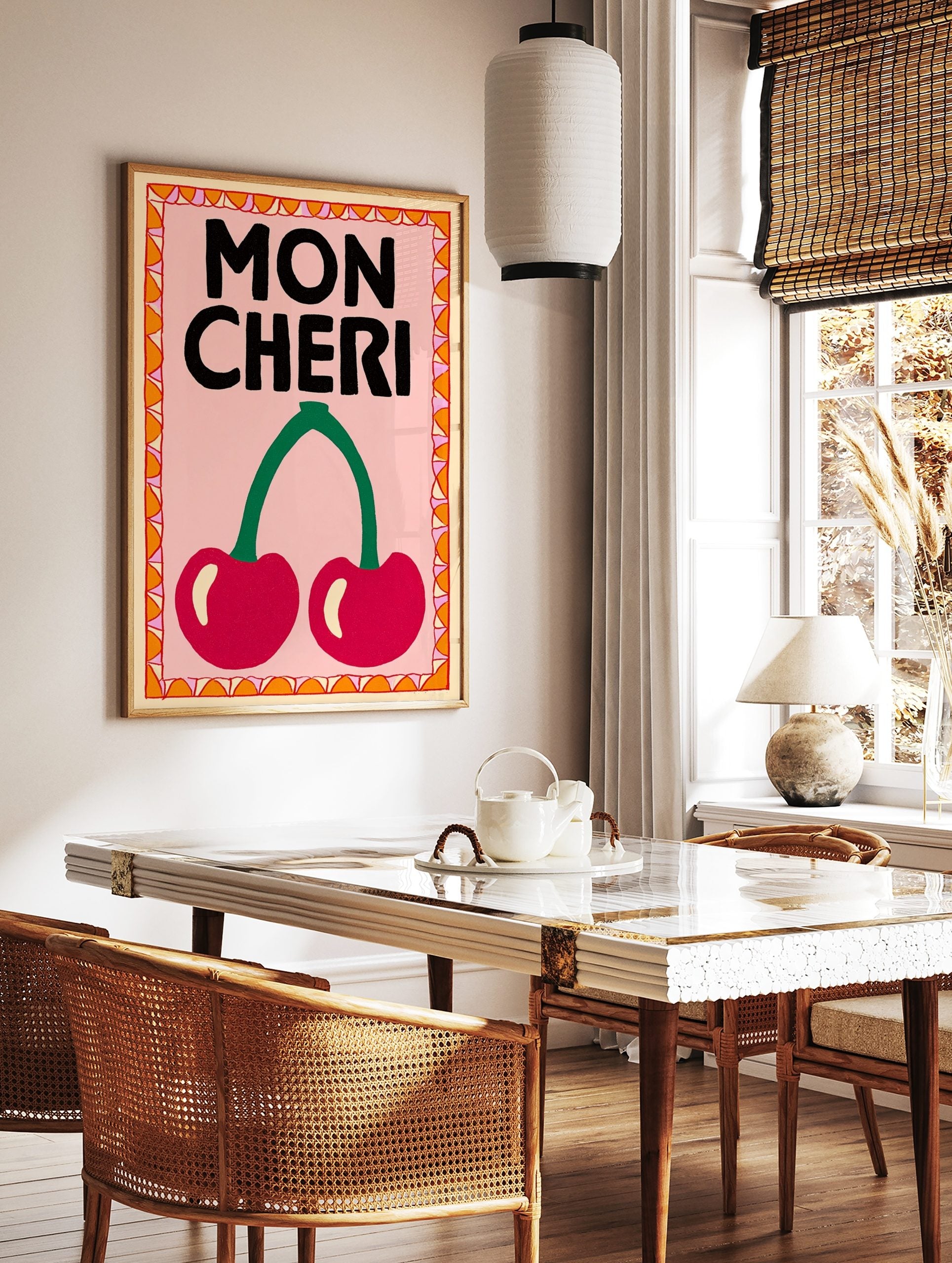 Mon Cheri typography wall art with two red cherries, green stem, pink background, and decorative, in a styled room mockup