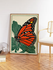 Monarch butterfly wall art print in linocut style with orange wings and green leaves on a cream background. - Image 2