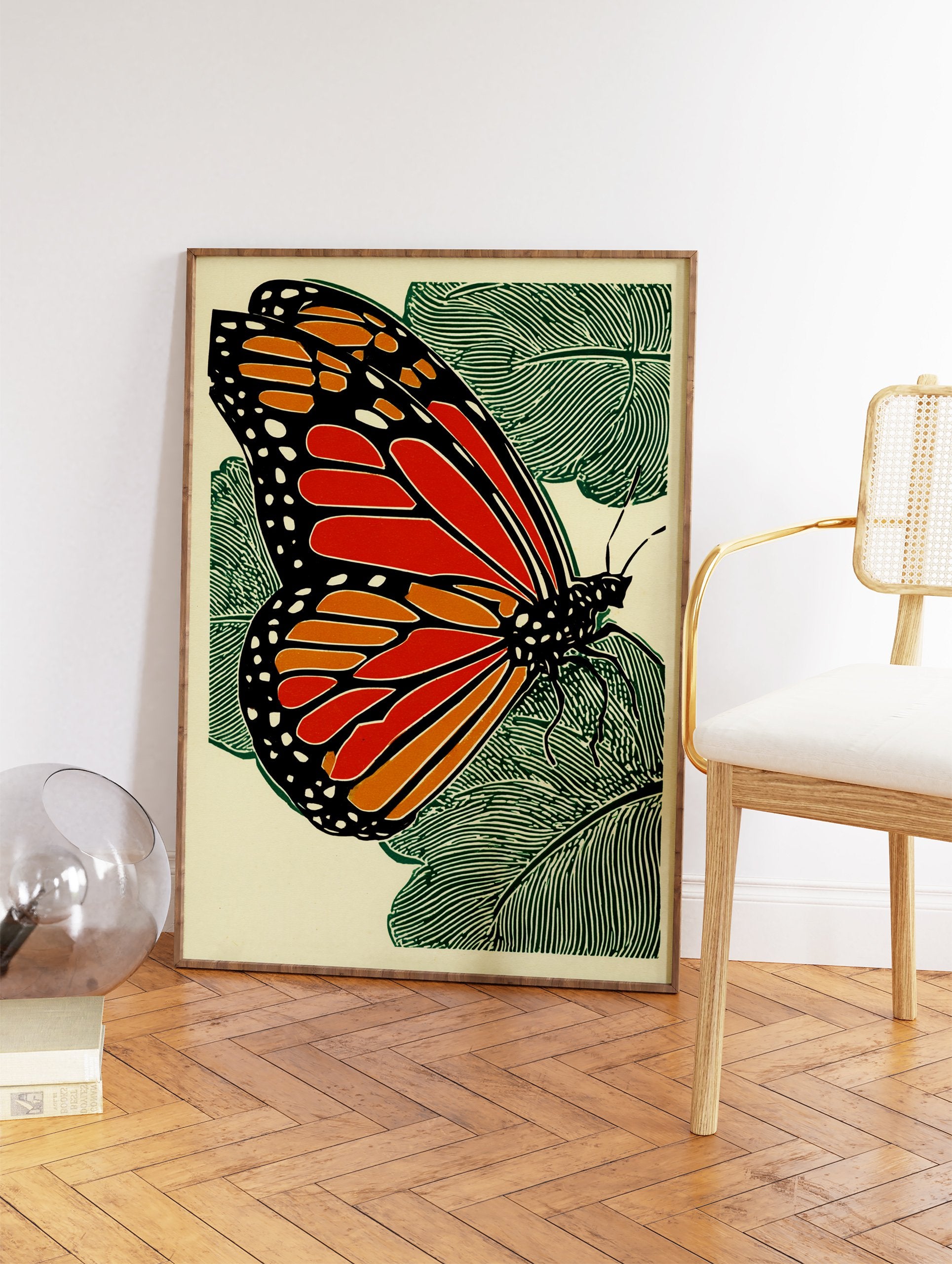 Monarch butterfly woodcut style print with orange, black, and green on a light background with leaves. - Image 2