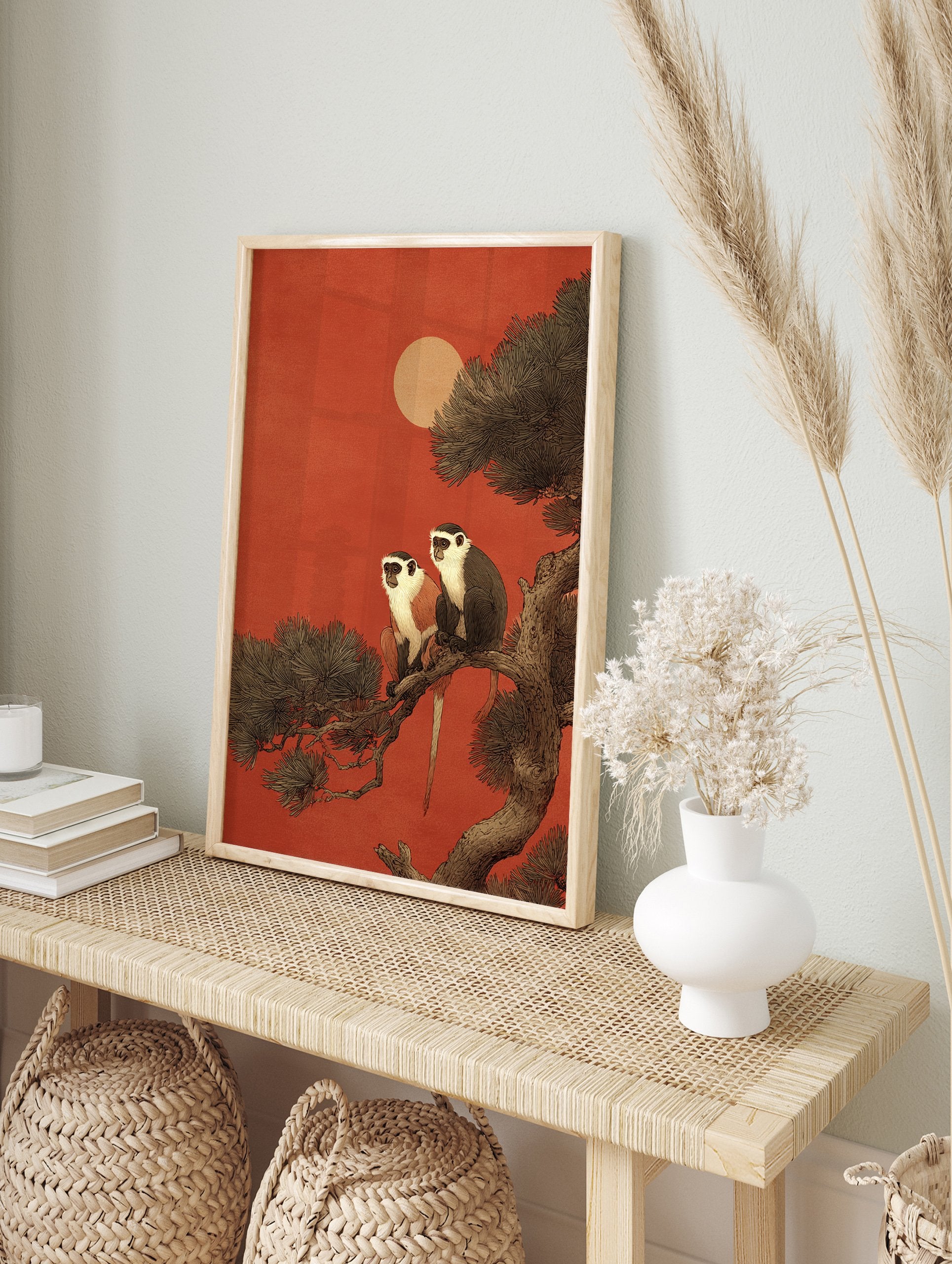 Illustration of two monkeys with white faces and chests sitting on a tree branch against a deep red sky with a pale sun. - Image 3