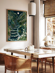 Illustrative art print of a moonlit stone staircase with a cascading waterfall and white flowers in, in a styled room mockup