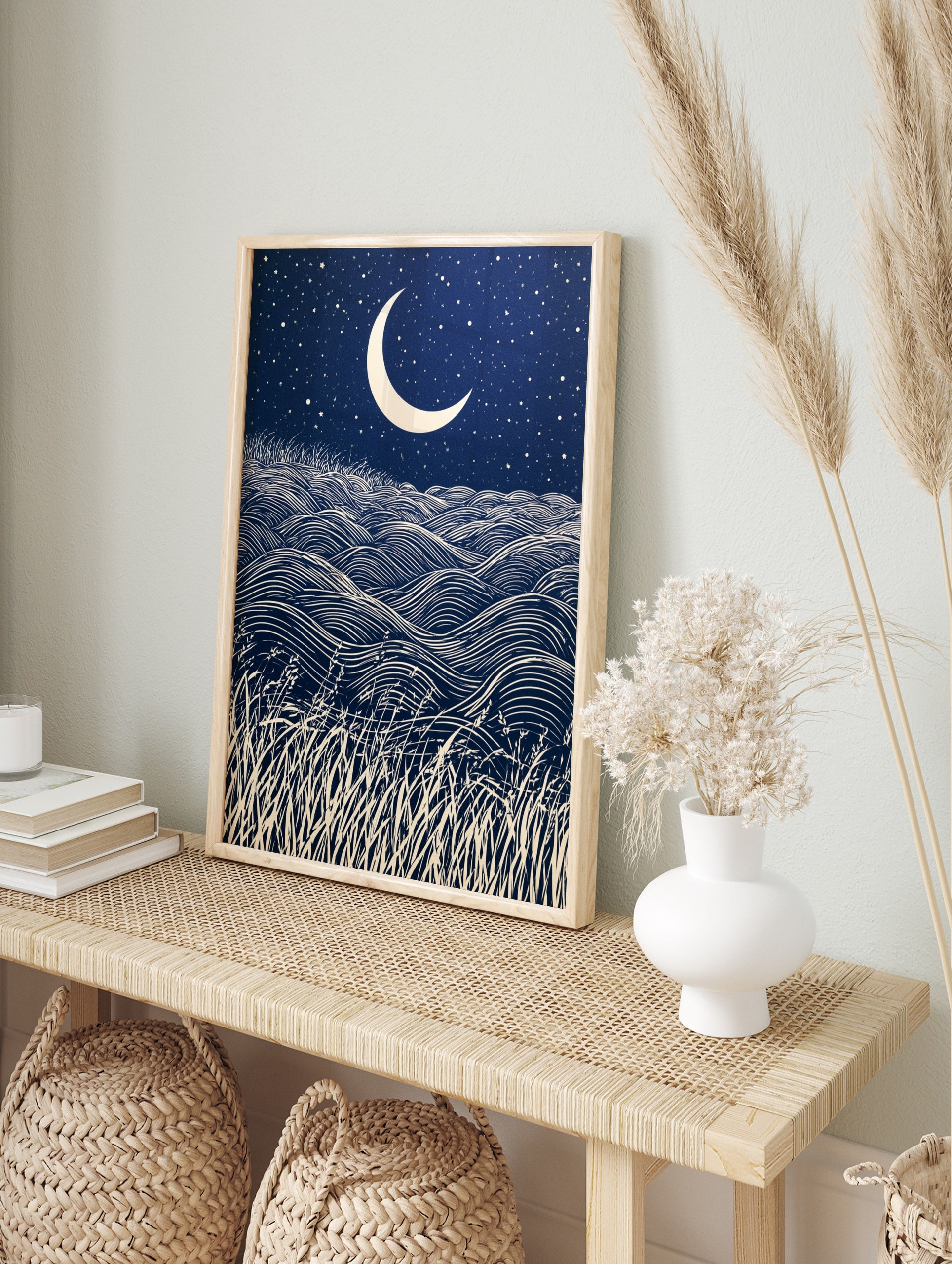 Crescent moon and starry night sky over rolling grass hills in a graphic, navy and cream, in an alternate framed mockup