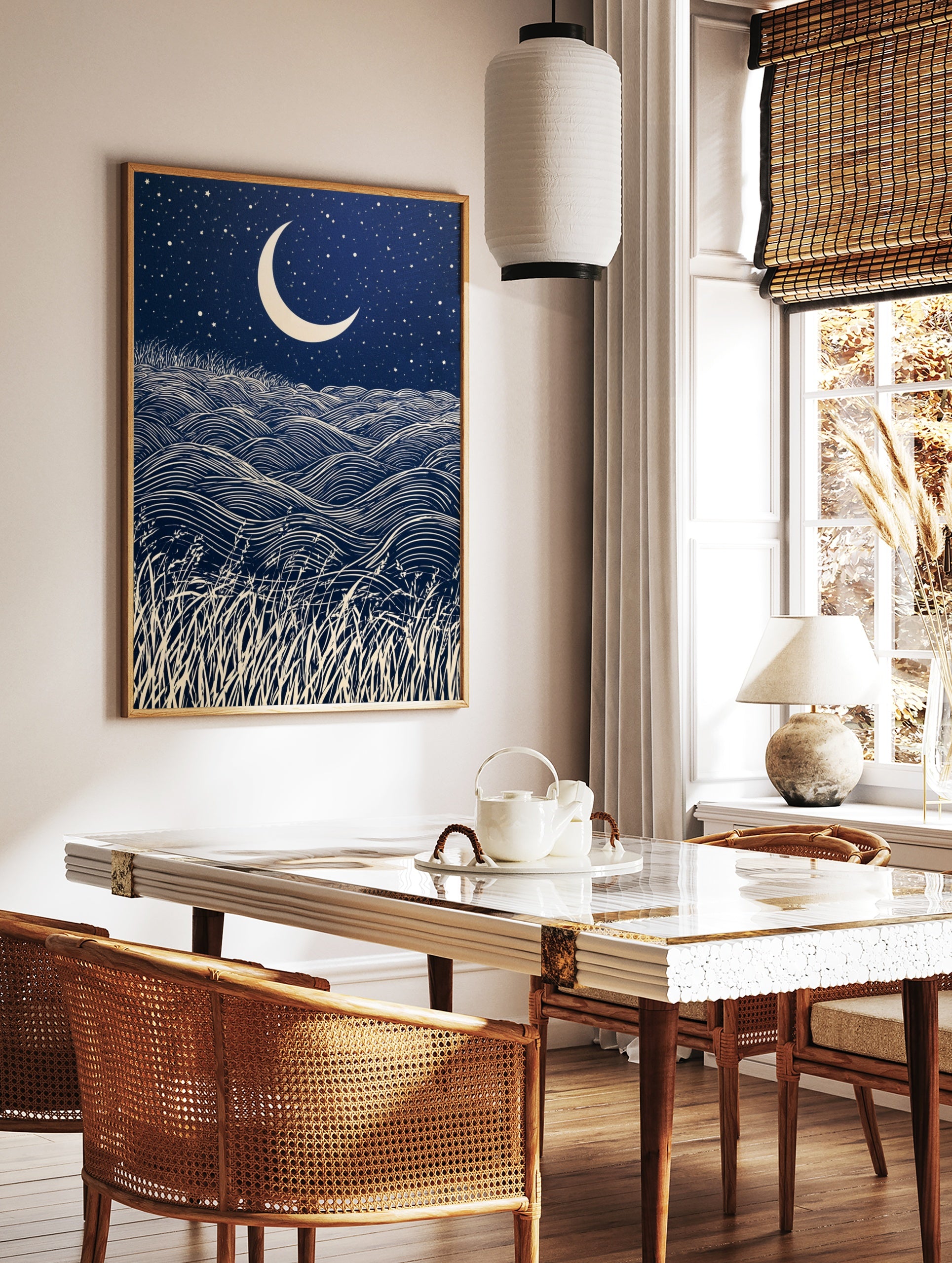 Crescent moon and starry night sky over rolling grass hills in a graphic, navy and cream, in a styled room mockup