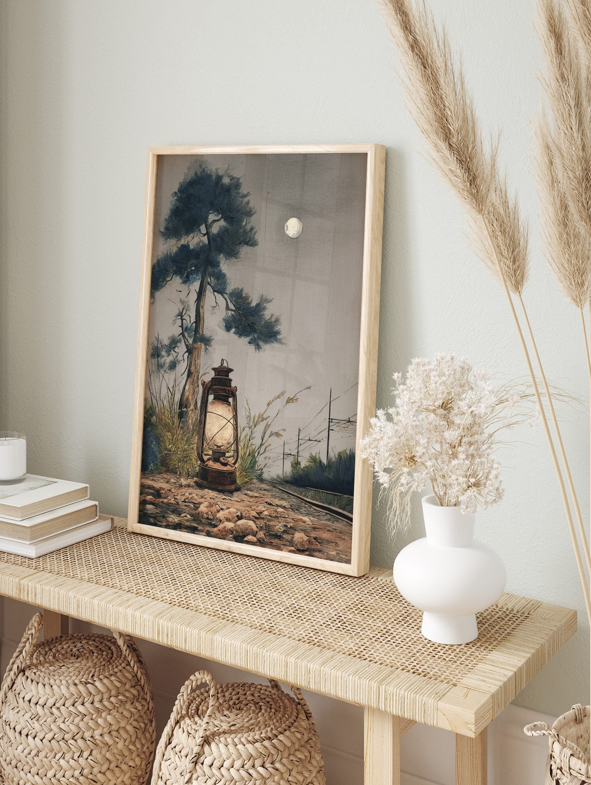 Moonlit illustrative art print of a glowing lantern, tall pine tree, railway tracks, and full, in an alternate framed mockup