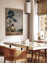 Moonlit illustrative art print of a glowing lantern, tall pine tree, railway tracks, and full moon, in a styled room mockup